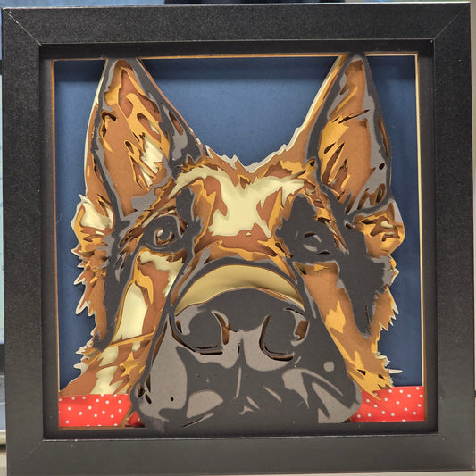 German Shepherd with head on table.